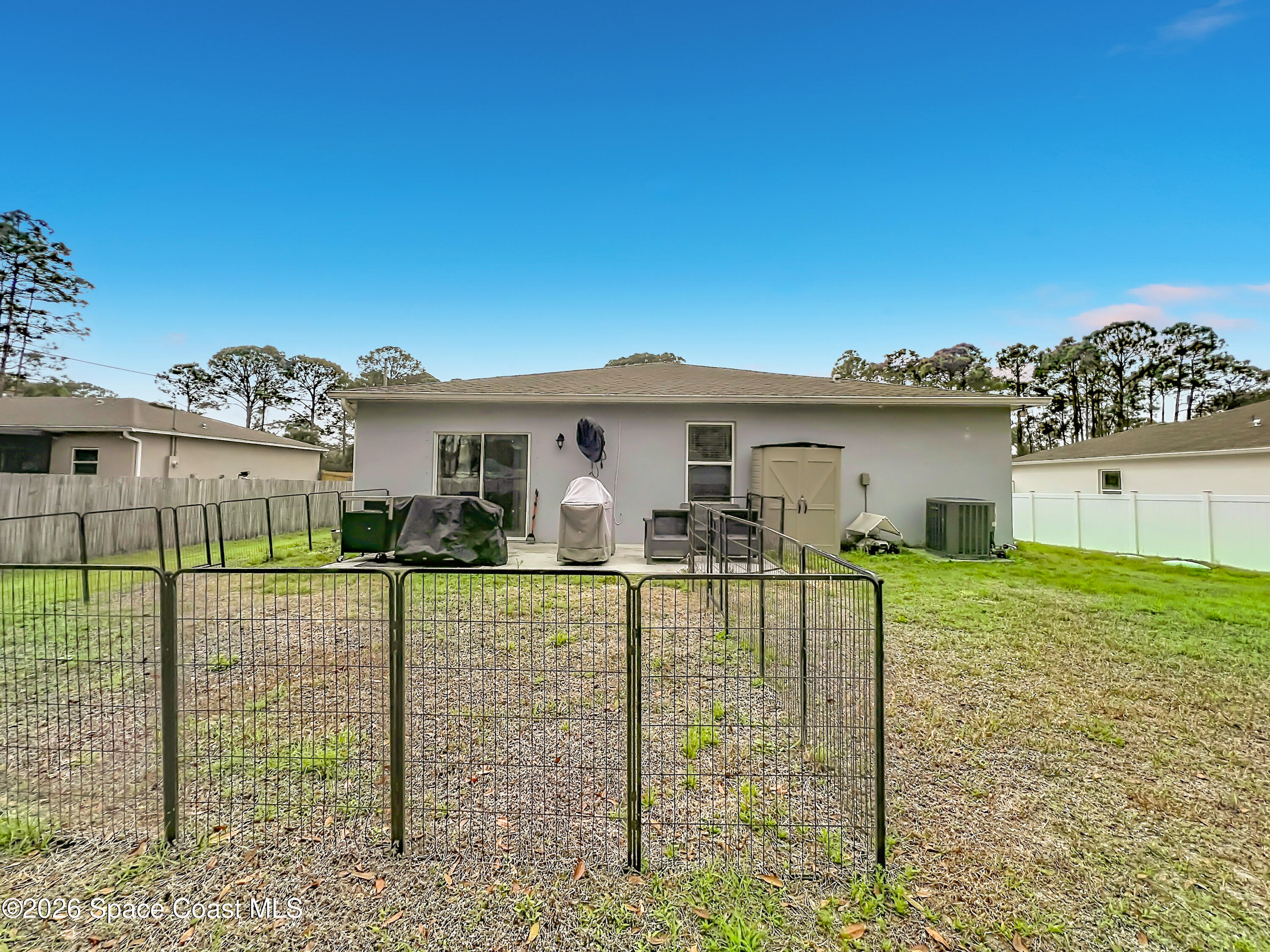 415 Scodella Street Southwest Palm Bay, FL 32908 - Photo 46 of 54 a view of a house with backyard and garden