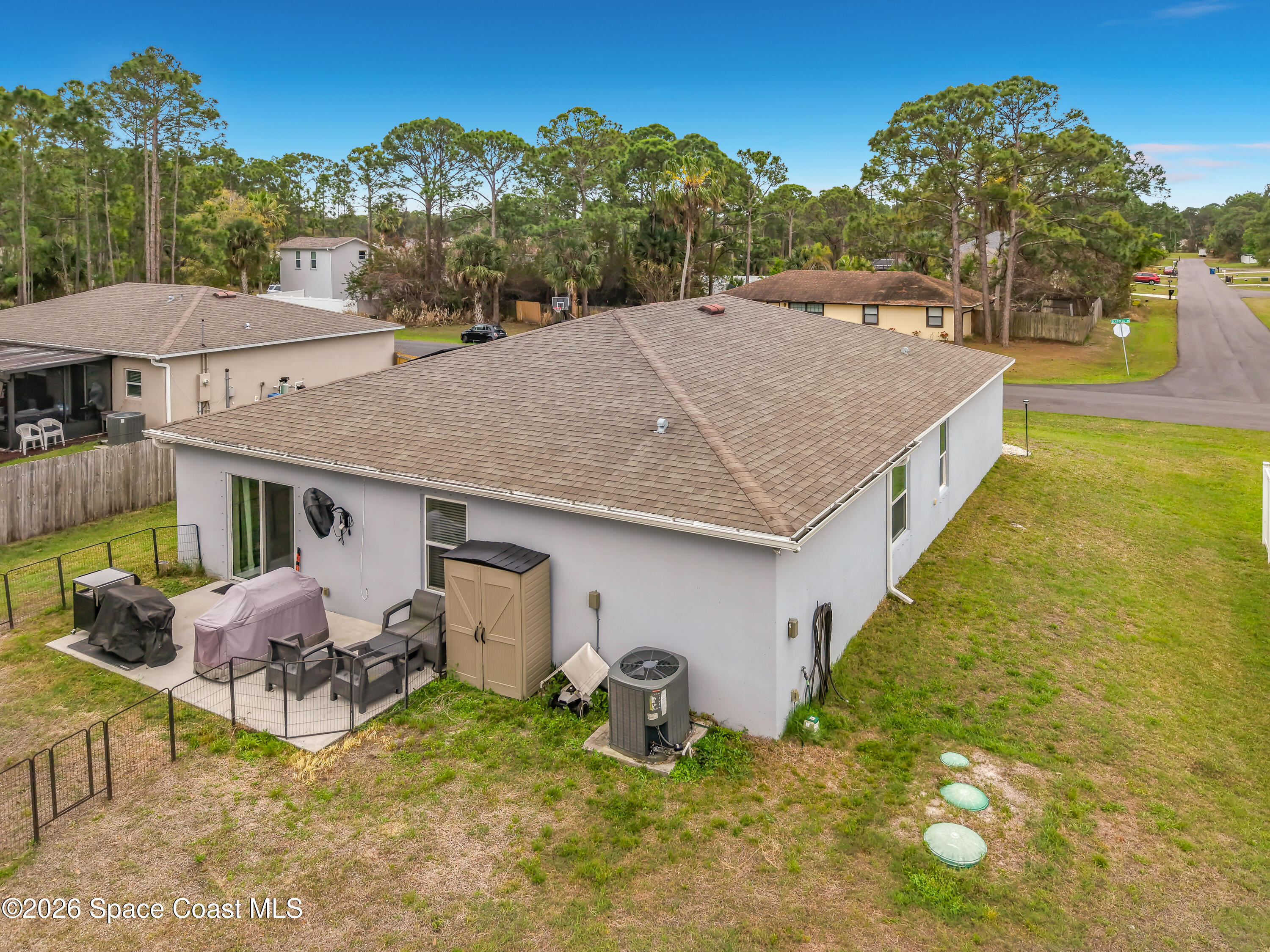 415 Scodella Street Southwest Palm Bay, FL 32908 - Photo 47 of 54 a aerial view of a house with table and chairs under an umbrella