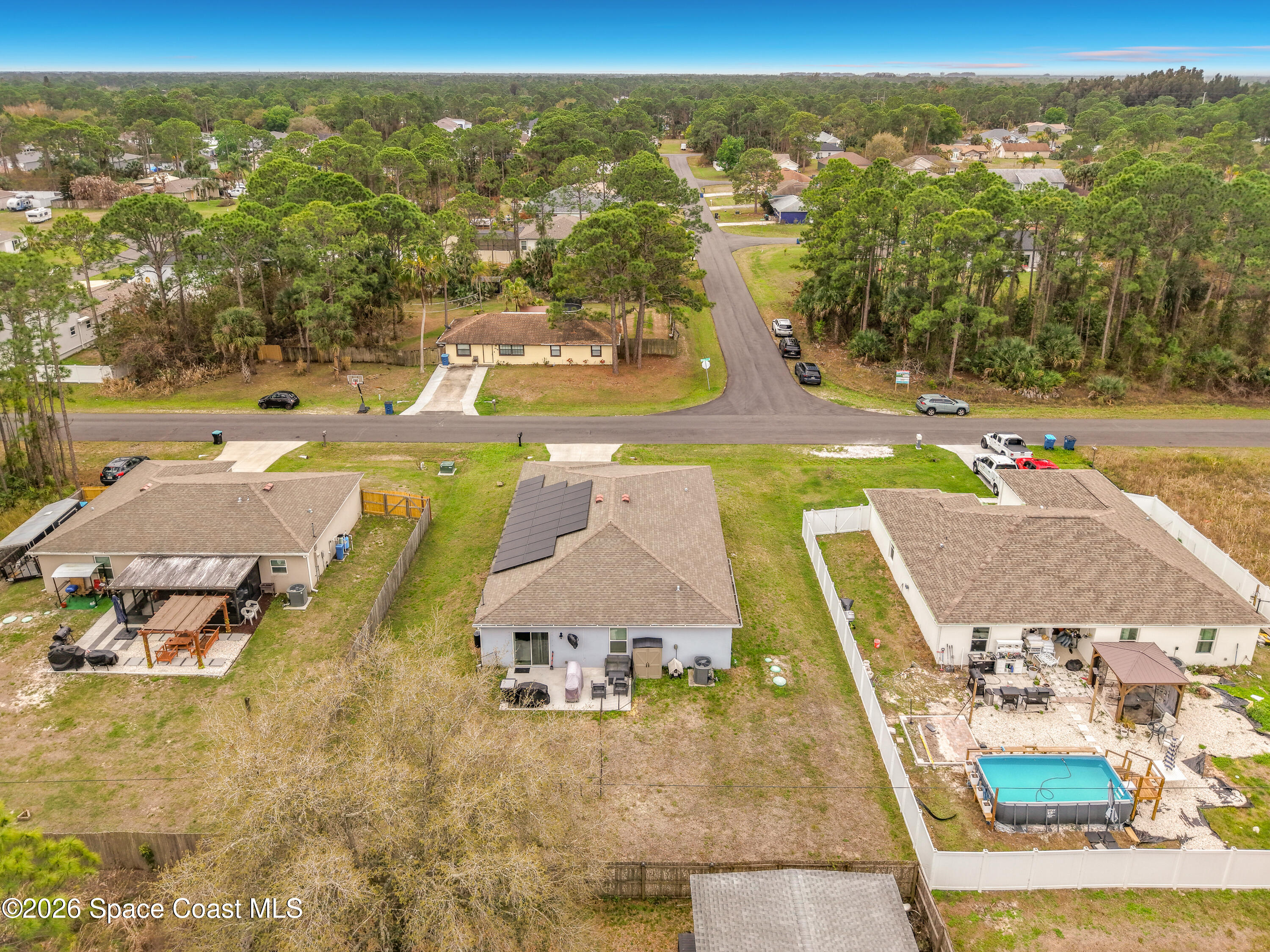 415 Scodella Street Southwest Palm Bay, FL 32908 - Photo 51 of 54 an aerial view of residential houses with outdoor space and city view
