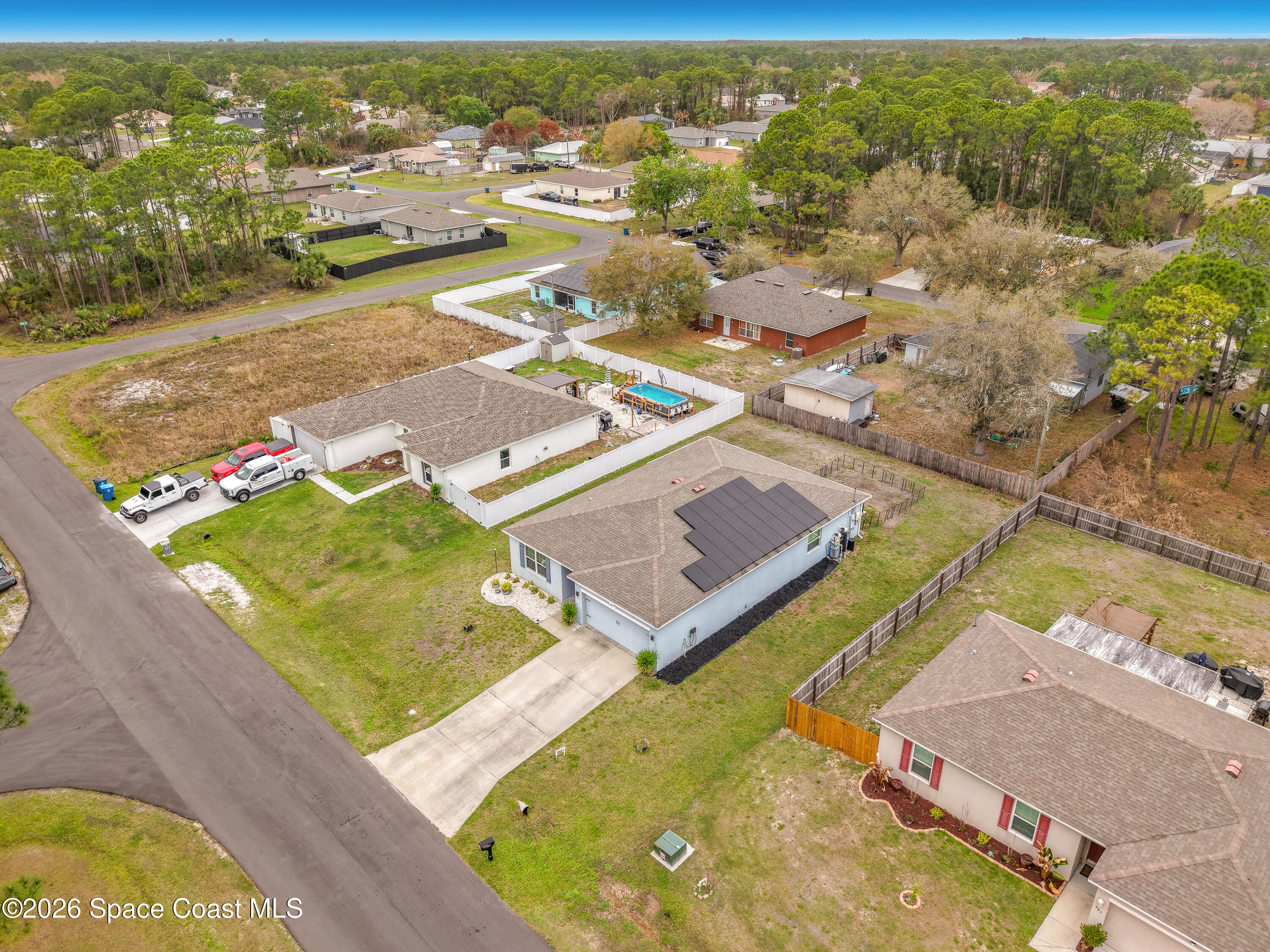 415 Scodella Street Southwest Palm Bay, FL 32908 - Photo 53 of 54 an aerial view of residential houses with outdoor space