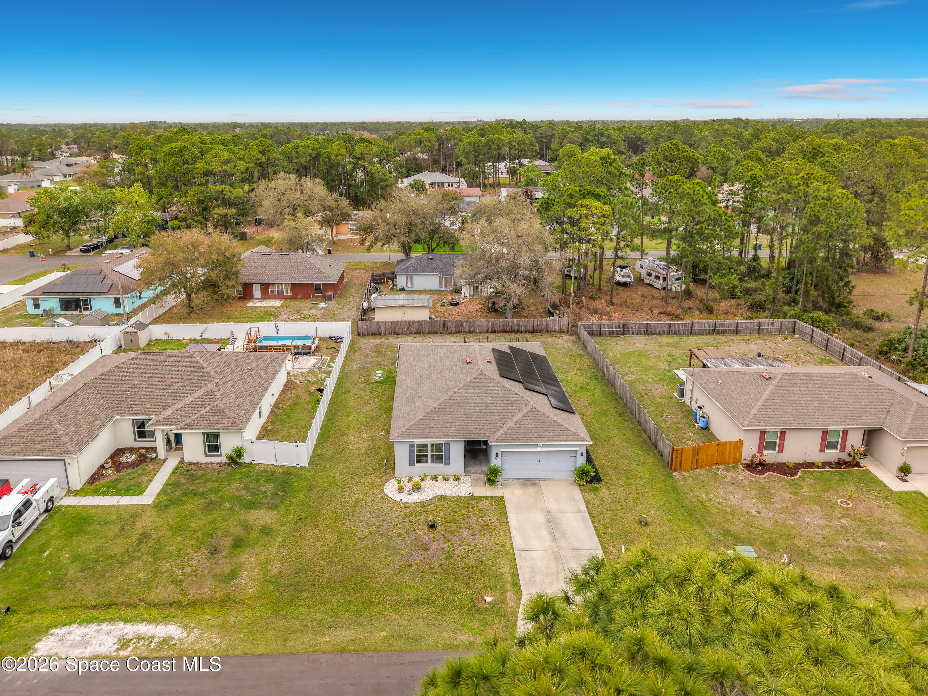 415 Scodella Street Southwest Palm Bay, FL 32908 - Photo 54 of 54 an aerial view of residential houses with outdoor space and swimming pool