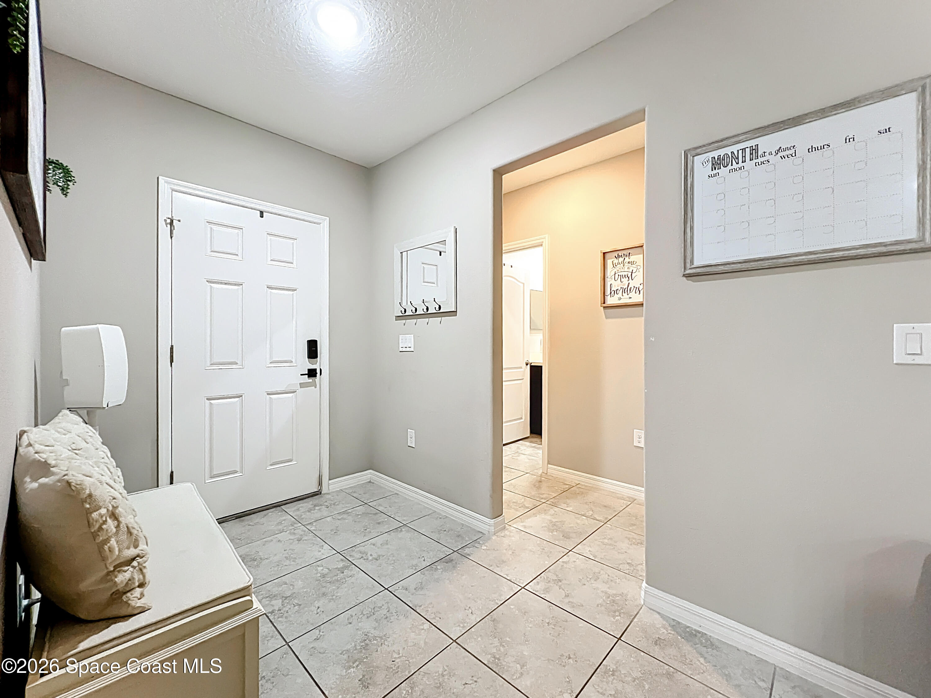 415 Scodella Street Southwest Palm Bay, FL 32908 - Photo 8 of 54 a living room with furniture and a gate