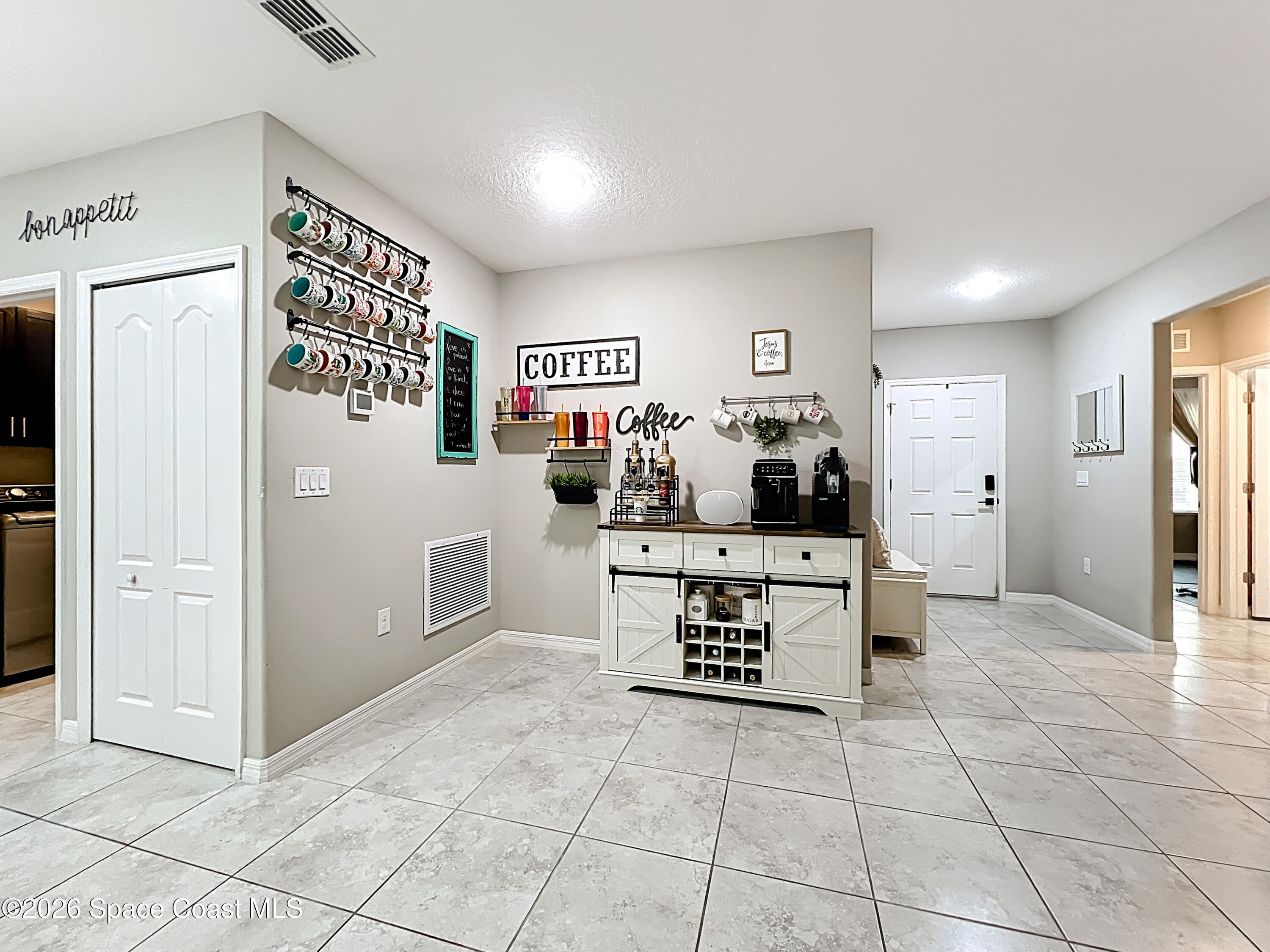 415 Scodella Street Southwest Palm Bay, FL 32908 - Photo 10 of 54 a kitchen with stainless steel appliances a refrigerator and a stove top oven