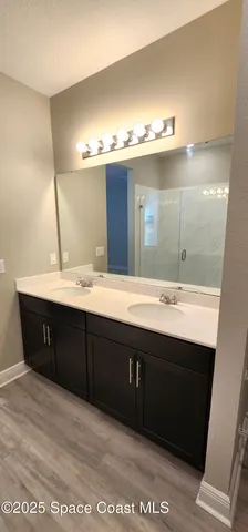 a bathroom with a sink double vanity and a mirror