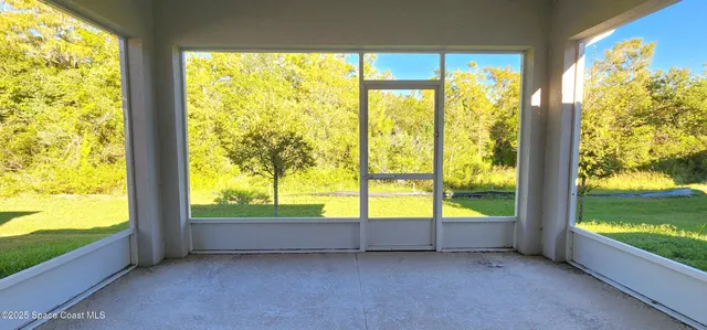 a view of an empty room with a large window