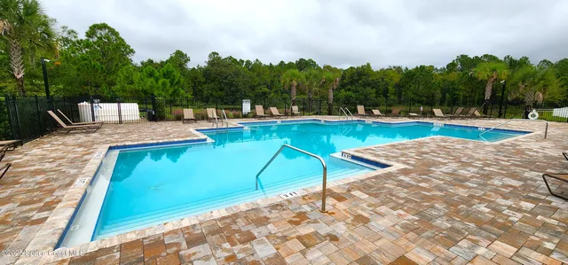 a view of a swimming pool with an outdoor space and seating area