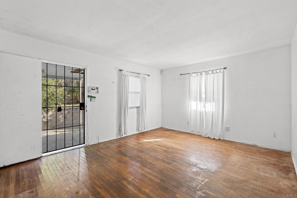 844 Saxony Road Encinitas, CA 92024 - Photo 13 of 31 a view of empty room with wooden floor and fan