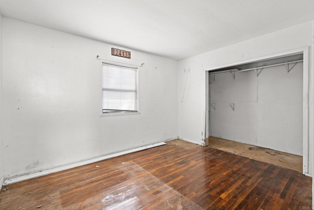844 Saxony Road Encinitas, CA 92024 - Photo 14 of 31 a view of an empty room with wooden floor and a window