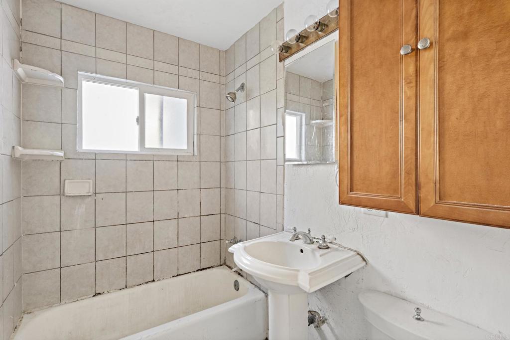 844 Saxony Road Encinitas, CA 92024 - Photo 16 of 31 a bathroom with a sink a toilet and shower