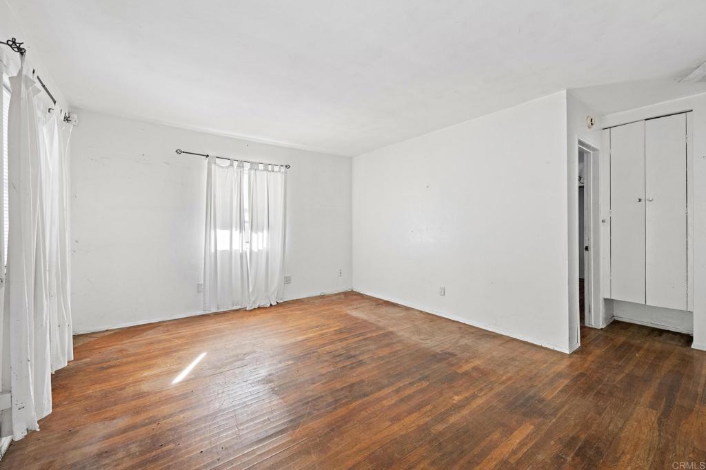 844 Saxony Road Encinitas, CA 92024 - Photo 10 of 31 a view of an empty room with wooden floor and window