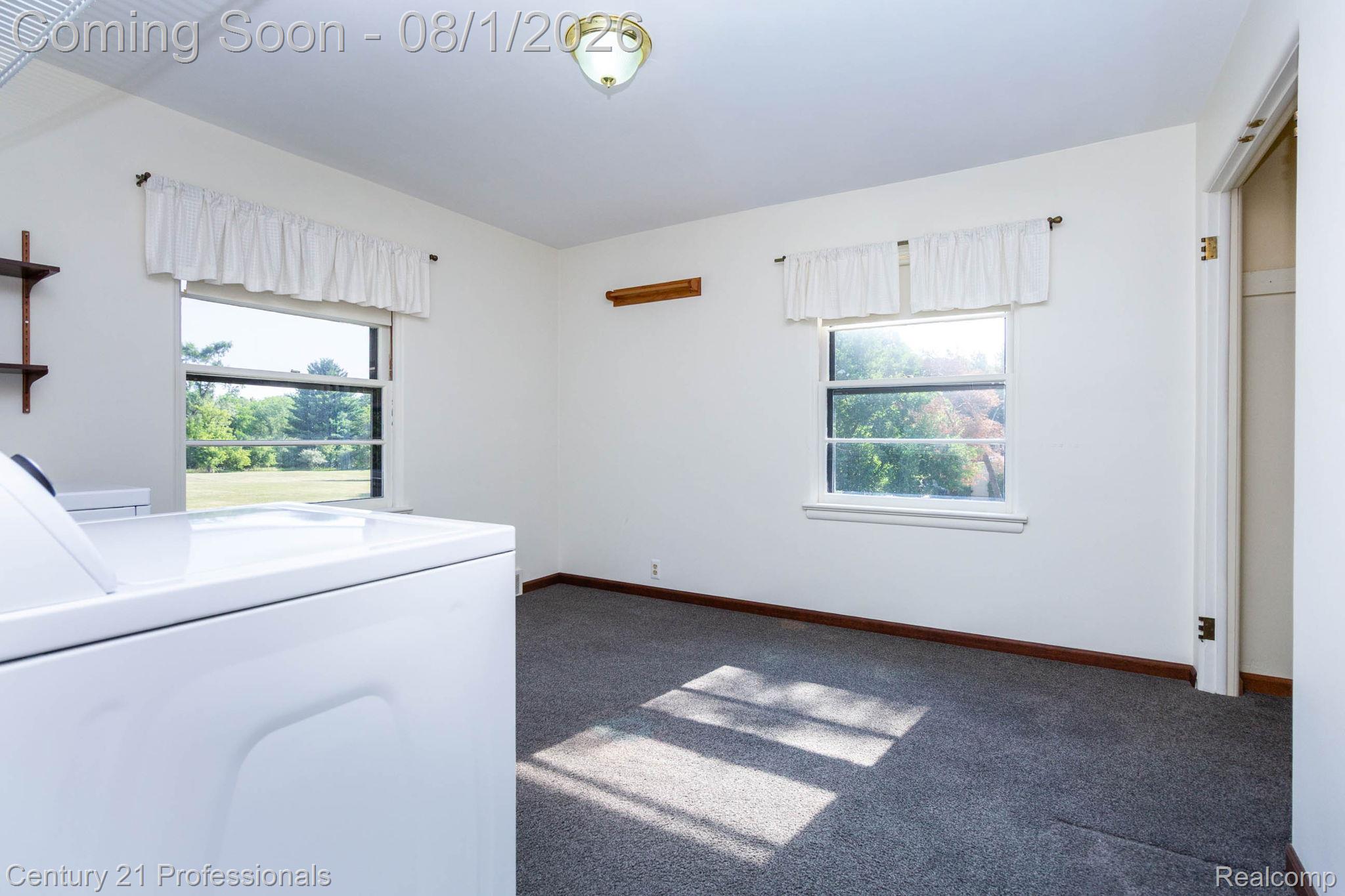 1365 East Buell Road Rochester, MI 48306 - Photo 21 of 56 Room featuring two windows, wall-mounted shelving, and a ceiling light fixture