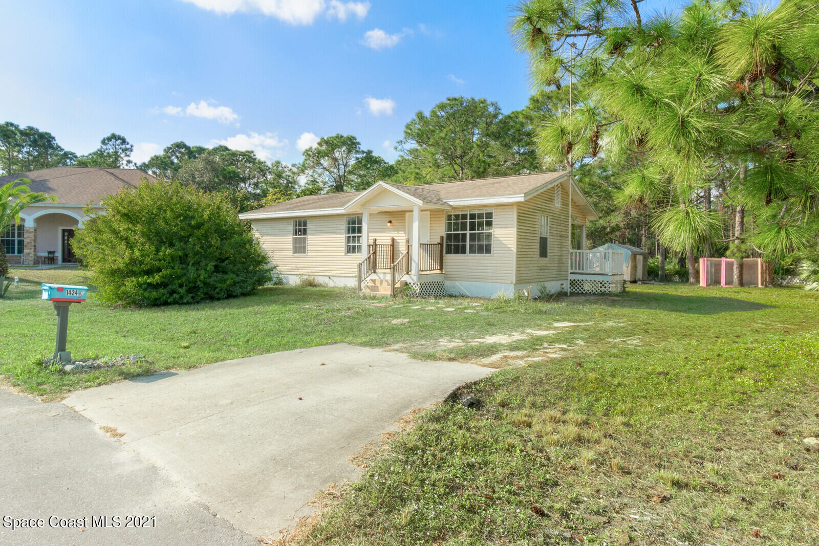 1424 Hanscom Road Southwest Palm Bay, FL 32908 - Photo 1 of 16 front view of a house with a yard