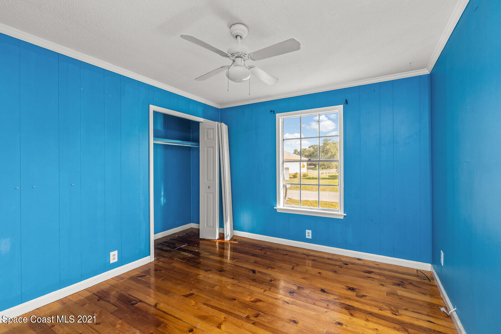 1424 Hanscom Road Southwest Palm Bay, FL 32908 - Photo 12 of 16 a view of a livingroom with a window and a ceiling fan