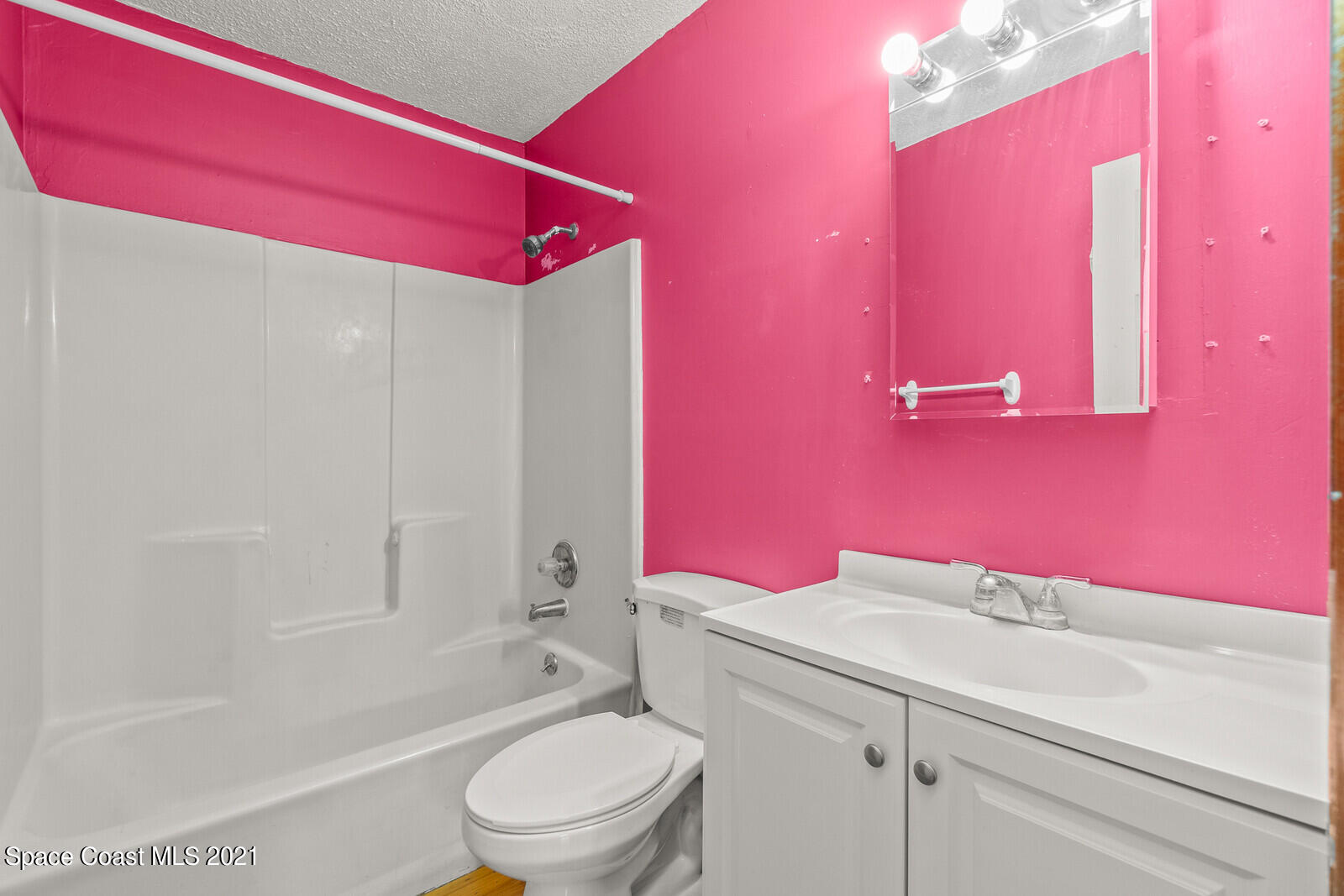 1424 Hanscom Road Southwest Palm Bay, FL 32908 - Photo 13 of 16 a bathroom with a granite countertop bathtub shower sink mirror vanity and toilet