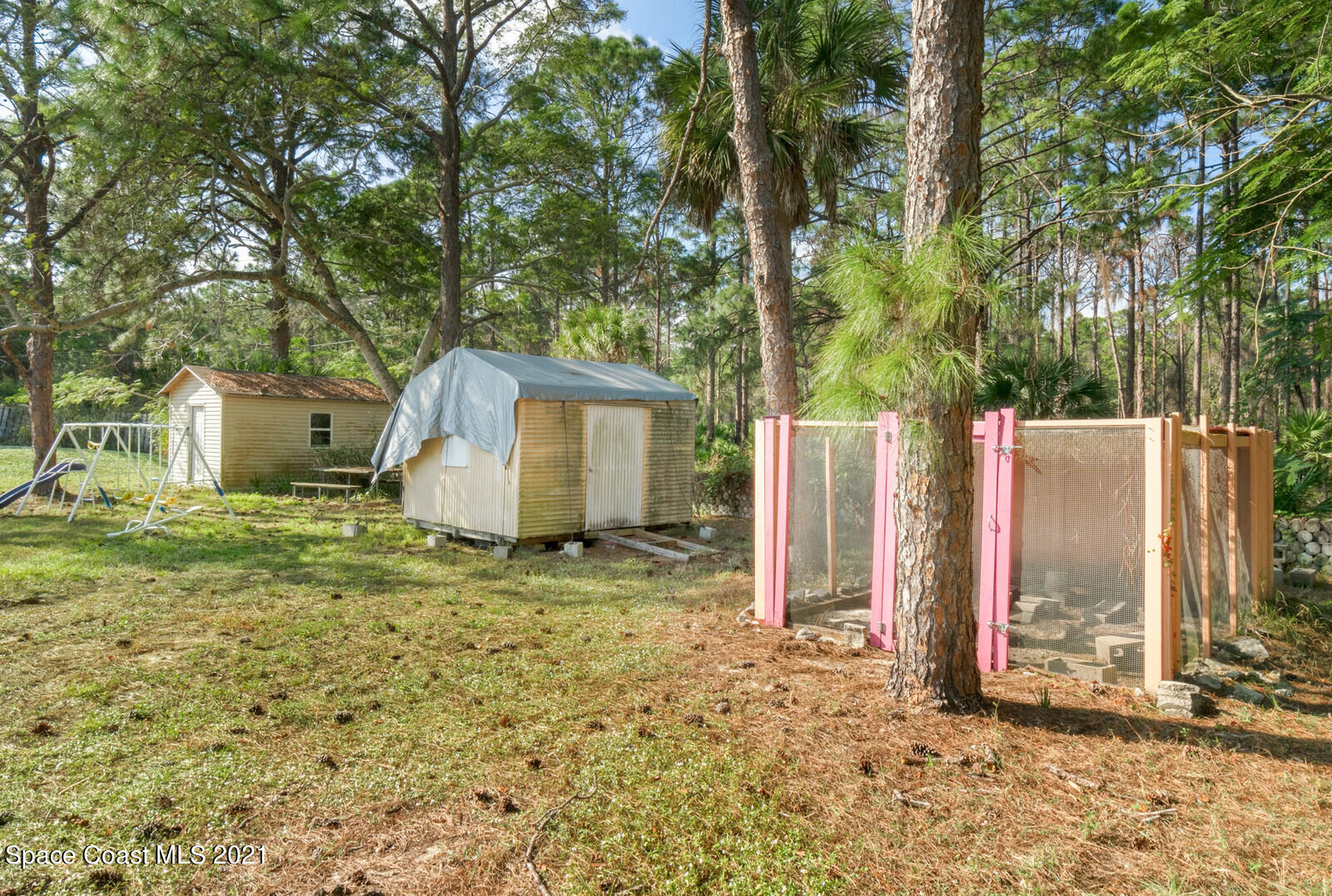 1424 Hanscom Road Southwest Palm Bay, FL 32908 - Photo 16 of 16 a backyard of a house with table and chairs