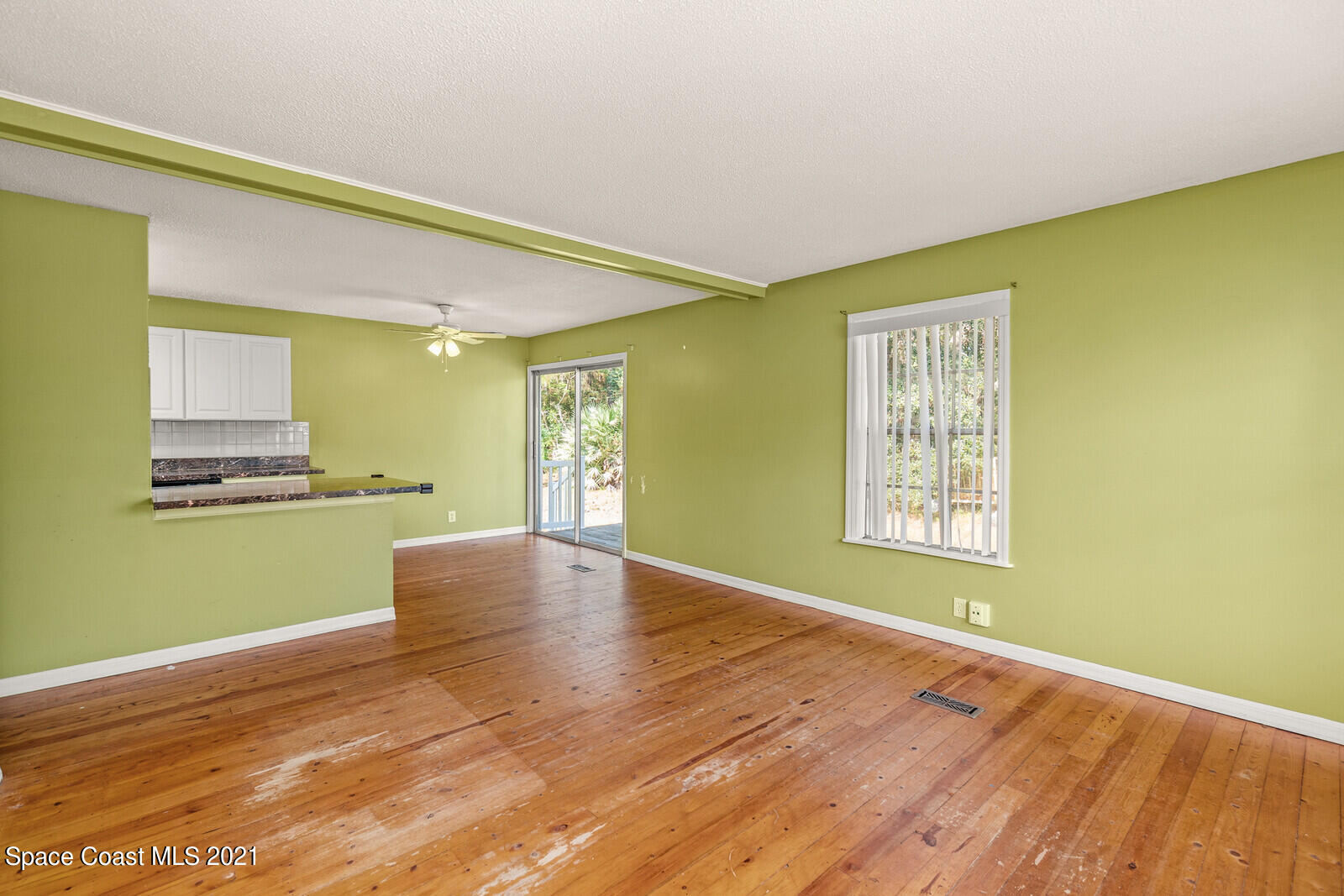 1424 Hanscom Road Southwest Palm Bay, FL 32908 - Photo 3 of 16 a view of an empty room with kitchen and a window
