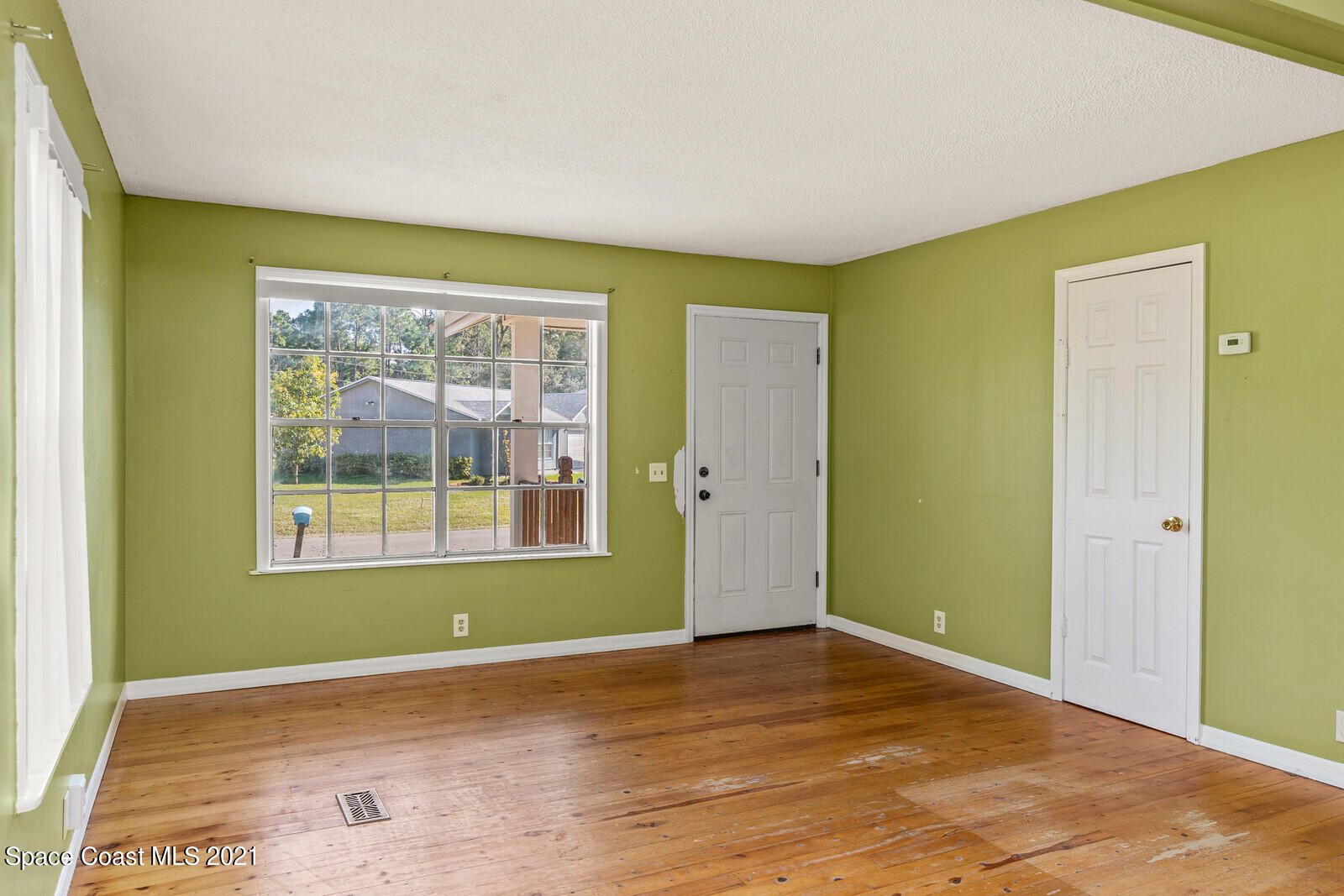 1424 Hanscom Road Southwest Palm Bay, FL 32908 - Photo 4 of 16 an empty room with a window