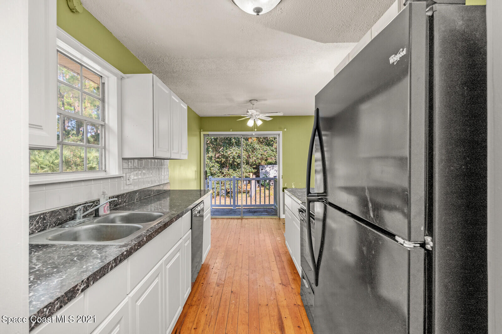 1424 Hanscom Road Southwest Palm Bay, FL 32908 - Photo 6 of 16 a kitchen with granite countertop a sink a counter top space and stainless steel appliances