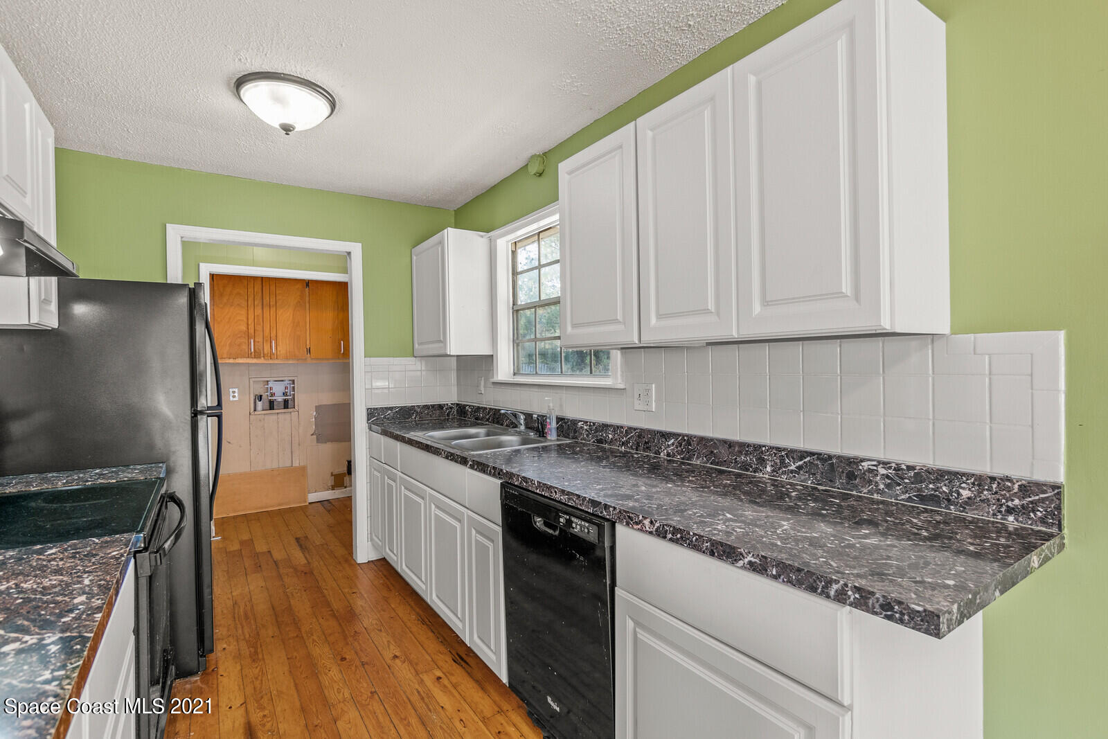 1424 Hanscom Road Southwest Palm Bay, FL 32908 - Photo 7 of 16 a kitchen with granite countertop wooden cabinets and a stove