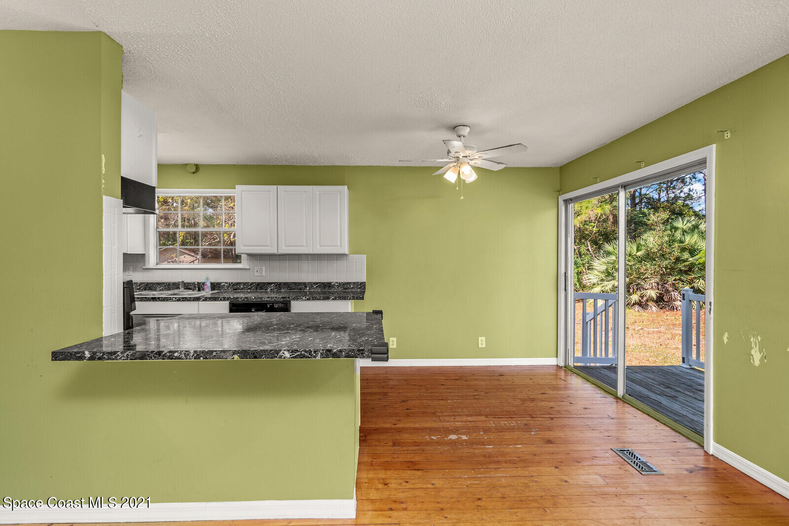 1424 Hanscom Road Southwest Palm Bay, FL 32908 - Photo 8 of 16 a kitchen with stainless steel appliances granite countertop a sink dishwasher and a refrigerator