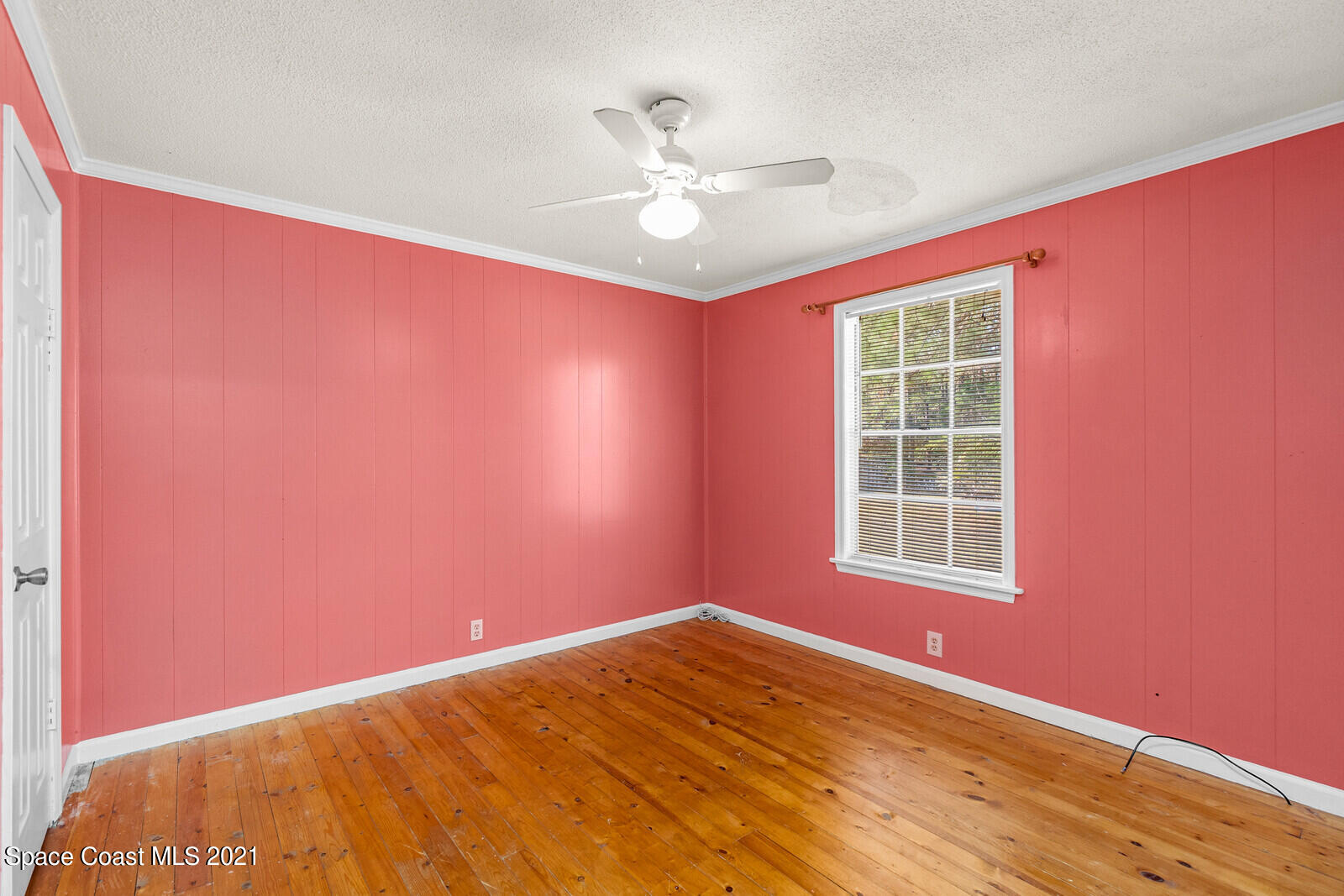 1424 Hanscom Road Southwest Palm Bay, FL 32908 - Photo 10 of 16 an empty room with windows and fan
