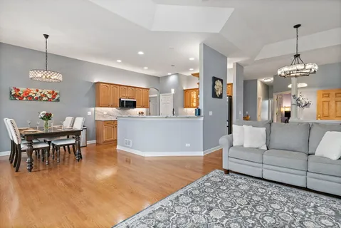 a living room with furniture and kitchen view