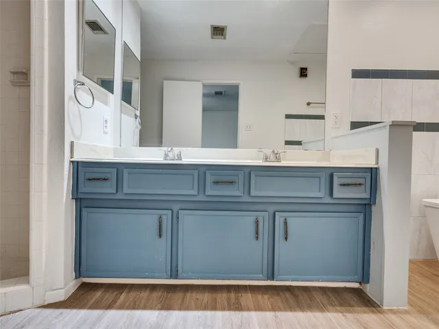 a bathroom with a double vanity sink and mirror