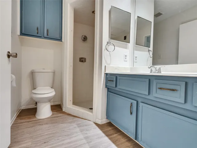 a large kitchen with a stove a refrigerator and a sink