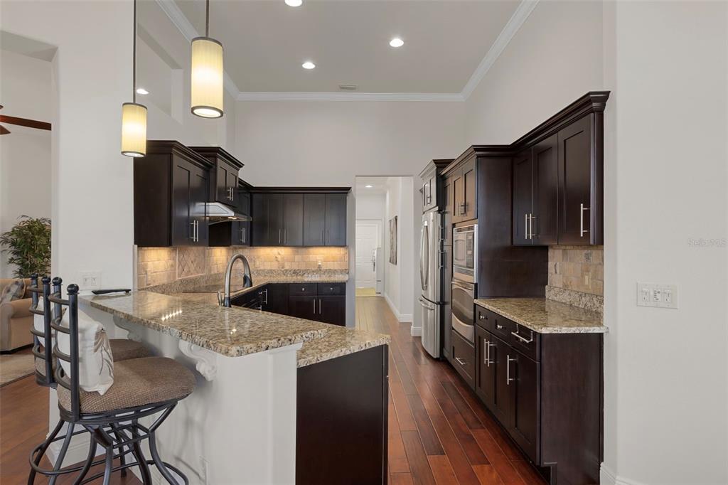 1601 North Tee Time Terrace Hernando, FL 34442 - Photo 4 of 69 a kitchen with stainless steel appliances kitchen island granite countertop a refrigerator and a stove top oven
