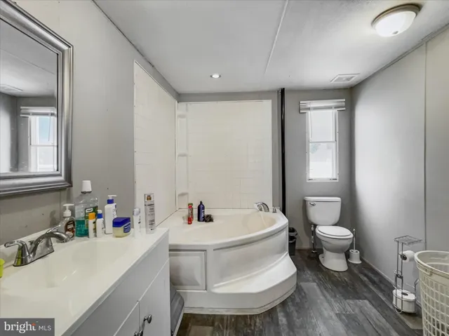 a white toilet sitting next to a bathroom sink