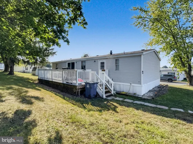 a view of backyard with a garden and deck