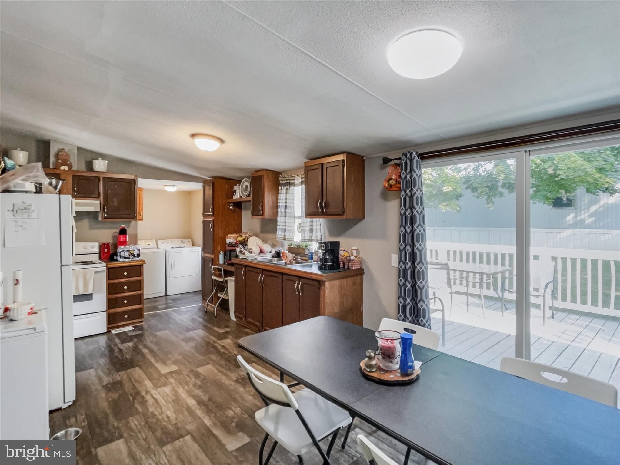 43 B Street York, PA 17408 - Photo 5 of 23 a kitchen with granite countertop a refrigerator a stove and a sink with wooden floor