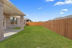 a front view of house with a garden