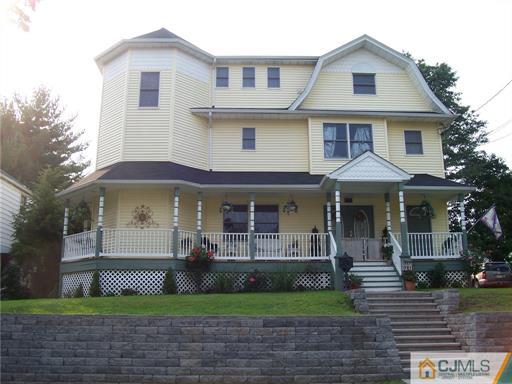 164 Eastern Way Rutherford, NJ 07070 - Photo 1 of 25 a front view of a house with a yard and potted plants