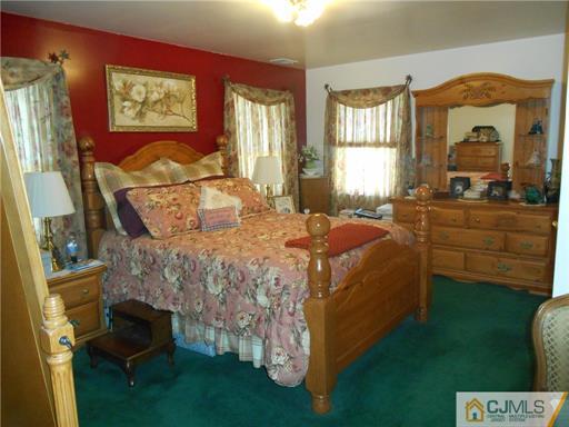 164 Eastern Way Rutherford, NJ 07070 - Photo 2 of 25 a bedroom with a bed and a mirror on the dresser