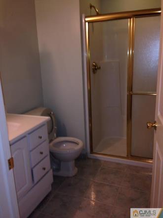 164 Eastern Way Rutherford, NJ 07070 - Photo 19 of 25 a bathroom with a toilet and a shower