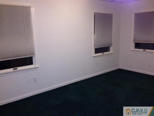 164 Eastern Way Rutherford, NJ 07070 - Photo 20 of 25 a view of an empty room with wooden floor and a window