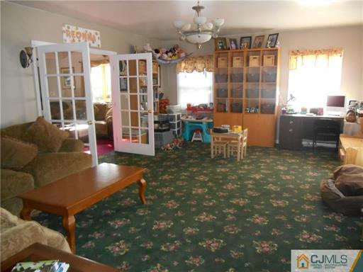 164 Eastern Way Rutherford, NJ 07070 - Photo 4 of 25 a living room with furniture and a floor to ceiling window