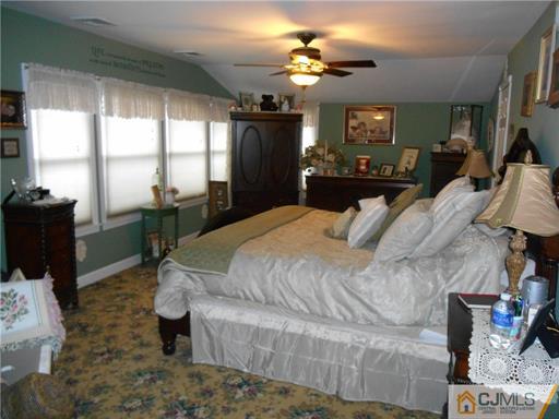 164 Eastern Way Rutherford, NJ 07070 - Photo 7 of 25 a bedroom with a bed lamps and window