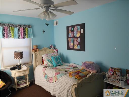 164 Eastern Way Rutherford, NJ 07070 - Photo 8 of 25 a bedroom with a bed and a chandelier