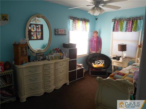 164 Eastern Way Rutherford, NJ 07070 - Photo 9 of 25 a living room with furniture and a mirror