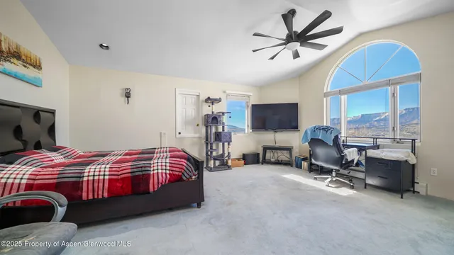 a bedroom with a bed and a chair