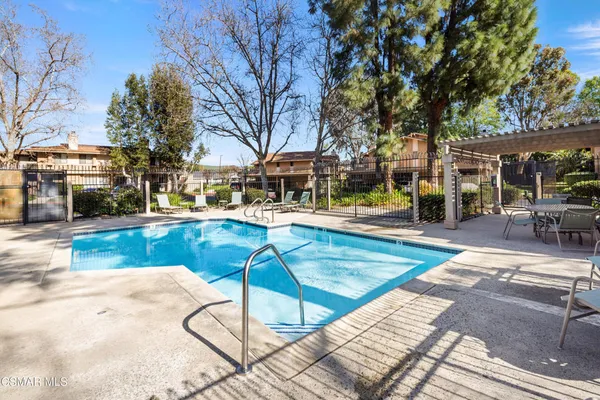 a swimming pool with outdoor seating and yard