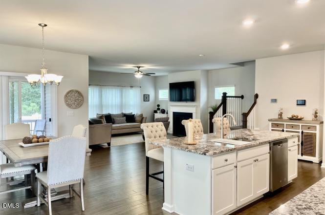1807 Wrenn Road Durham, NC 27703 - Photo 13 of 43 a living room with furniture kitchen view and a chandelier