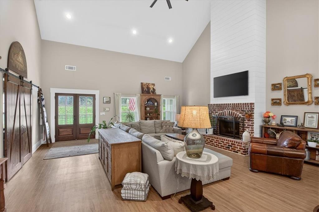 14402 Fincher Road Ball Ground, GA 30107 - Photo 11 of 55 a living room with furniture a fireplace and a flat screen tv