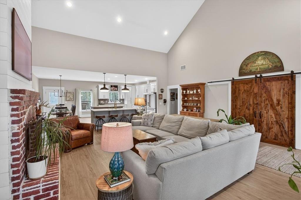 14402 Fincher Road Ball Ground, GA 30107 - Photo 13 of 55 a living room with furniture a rug potted plant and a large window