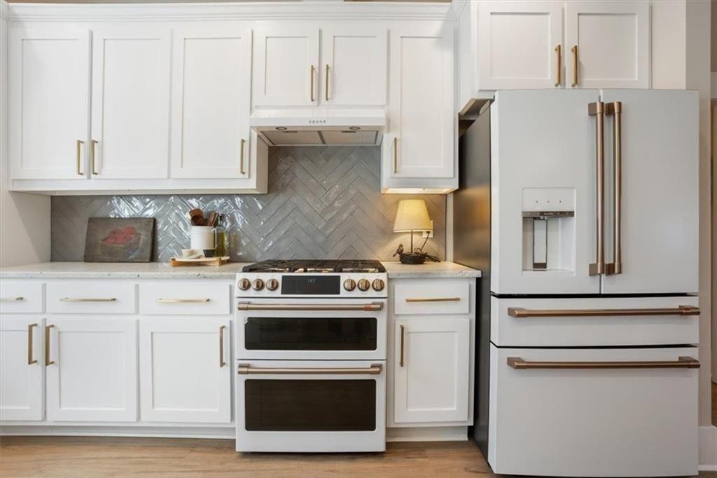 14402 Fincher Road Ball Ground, GA 30107 - Photo 19 of 55 a kitchen with stainless steel appliances granite countertop white cabinets and a stove