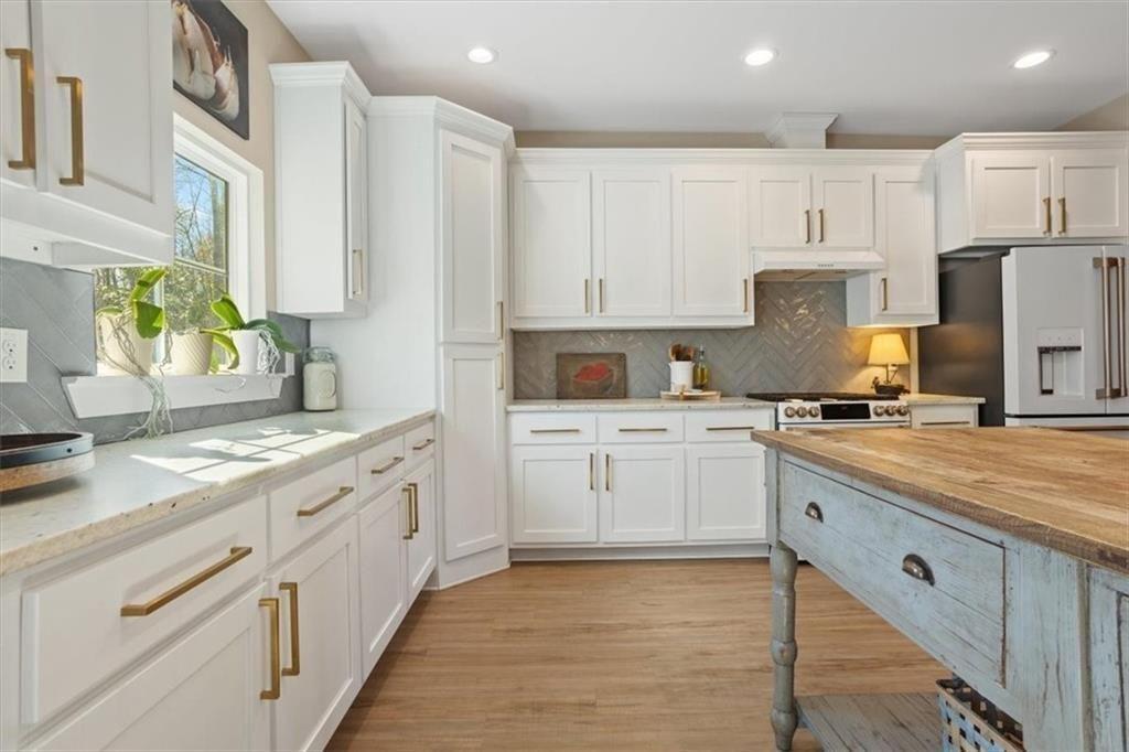 14402 Fincher Road Ball Ground, GA 30107 - Photo 22 of 55 a kitchen with kitchen island granite countertop white cabinets white stainless steel appliances with a sink and dishwasher