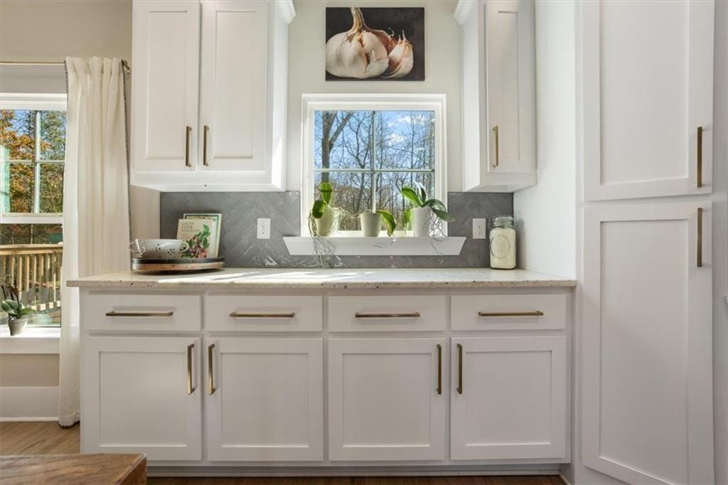 14402 Fincher Road Ball Ground, GA 30107 - Photo 23 of 55 a kitchen with white cabinets and a window