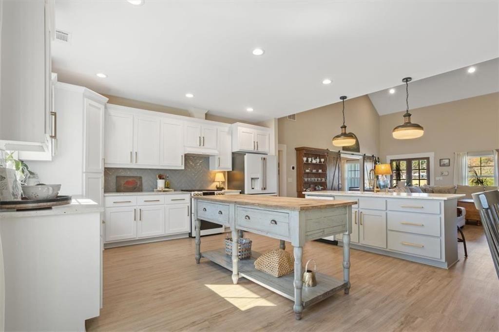 14402 Fincher Road Ball Ground, GA 30107 - Photo 25 of 55 a kitchen with cabinets a sink and chairs in it